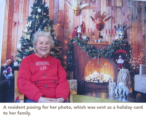 A resident posing for her photo, which was sent as a holiday card to her family.